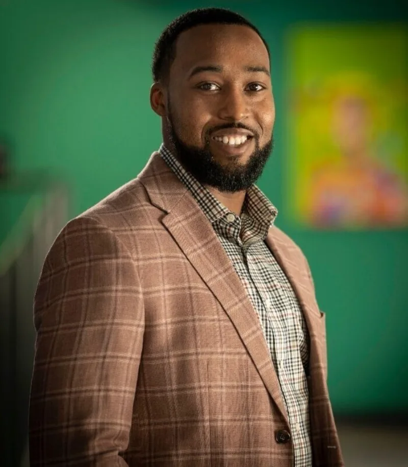 A man wearing a plaid jacket