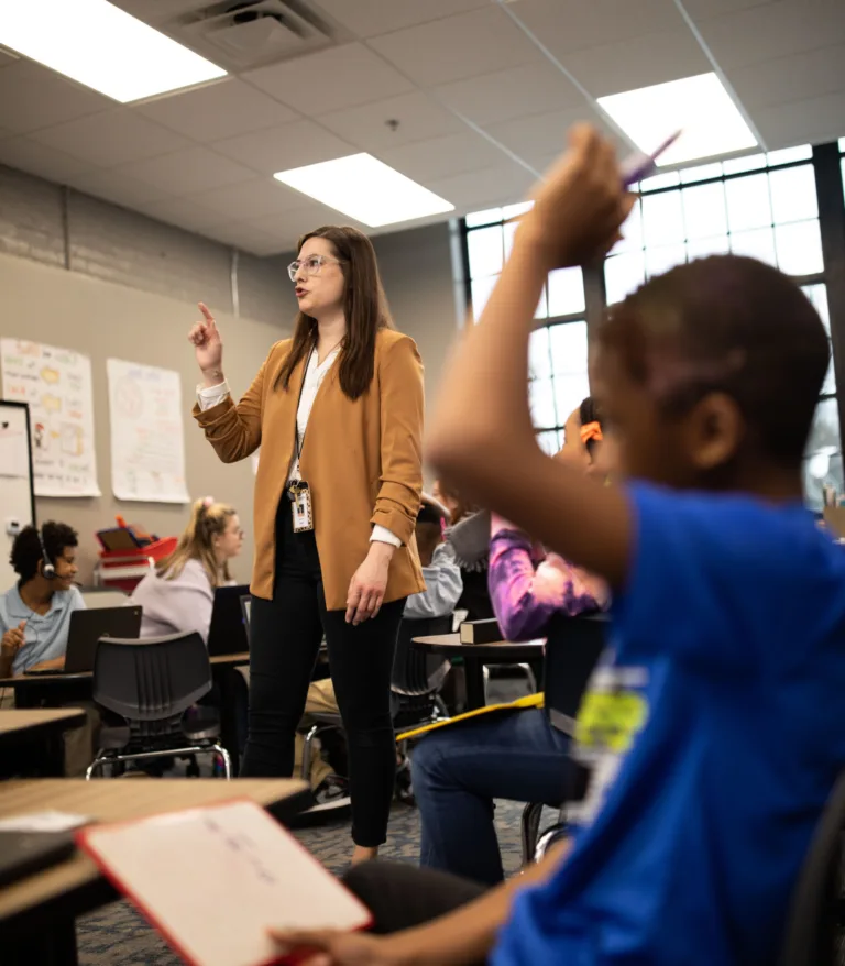 A woman teaching in front of her students