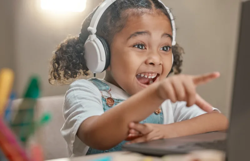 Young Girl Pointing At A Computer Screen