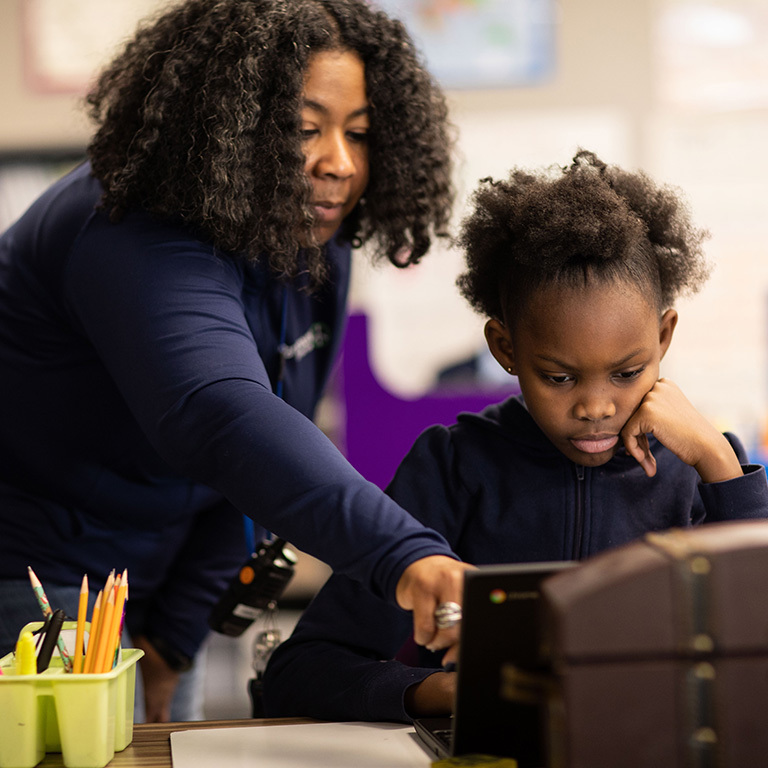 Paramount Schools teacher helping a student